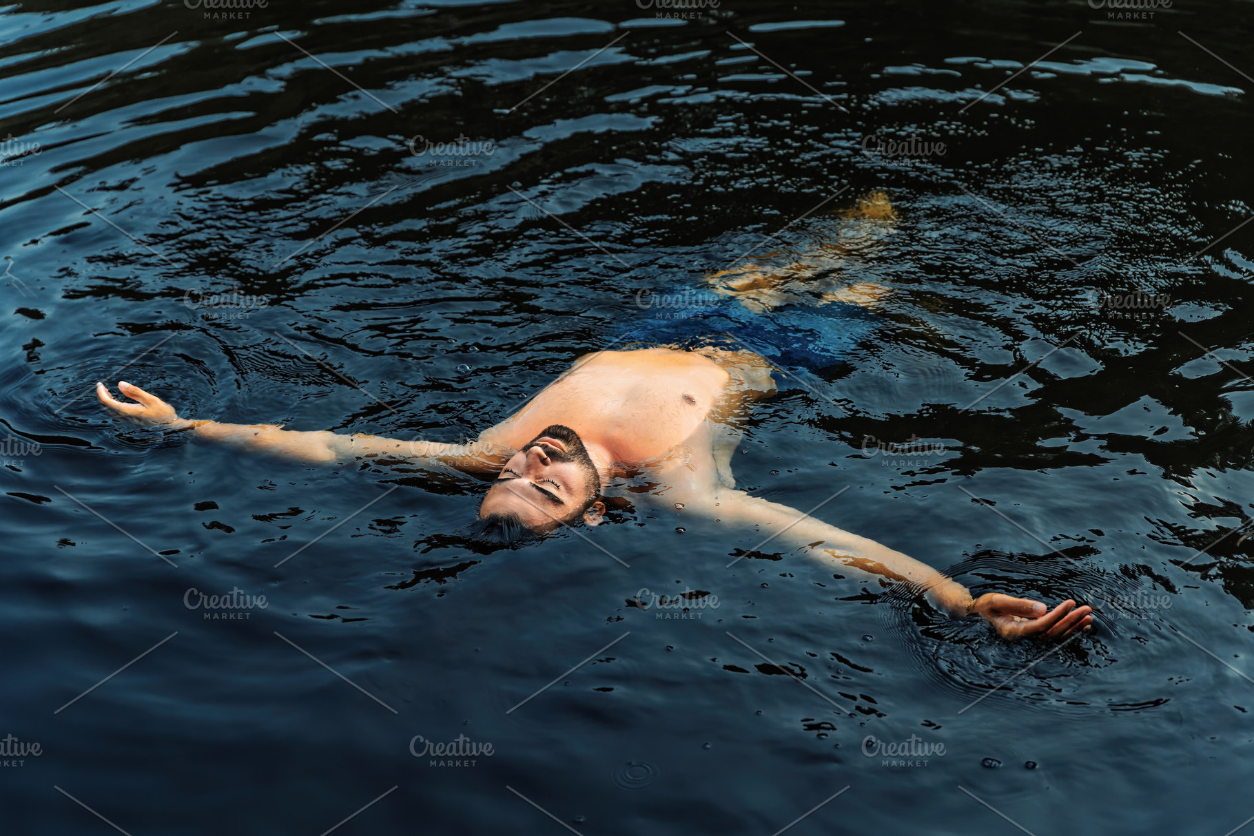 Relaxed man floating in natural dark, a Holiday Photo by Perpis