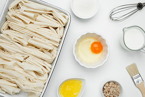 Crinkle Cake baking, filo dough in a baking dish near milk, eggs, butter, butte, a Photo by matucha