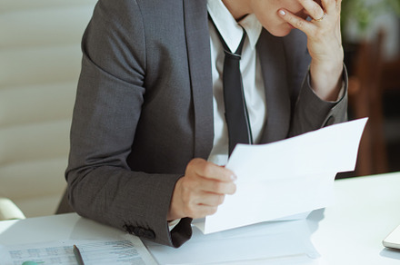 unhappy modern female worker in modern green office, a Business Photo by Alliance Images