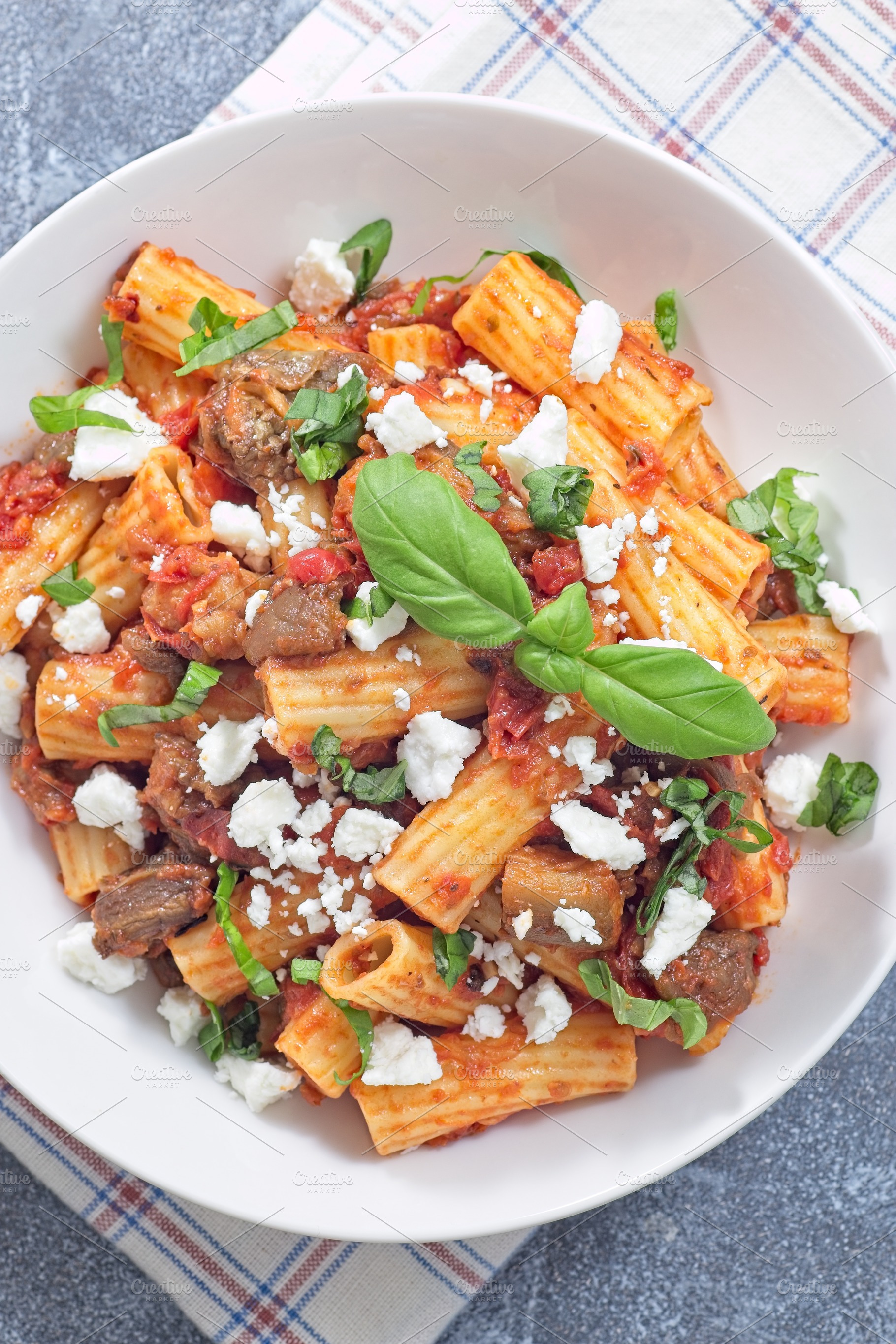Rigatoni alla Norma pasta with eggplant, tomato, basil and ricotta salata, hori, a Food & Drink Photo by iuliia_n
