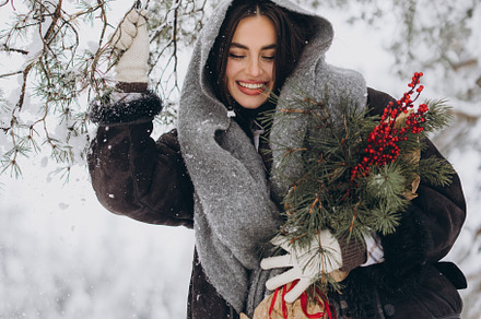Happy woman holding winter bouquet, a Holiday Photo by Cherkas Photography
