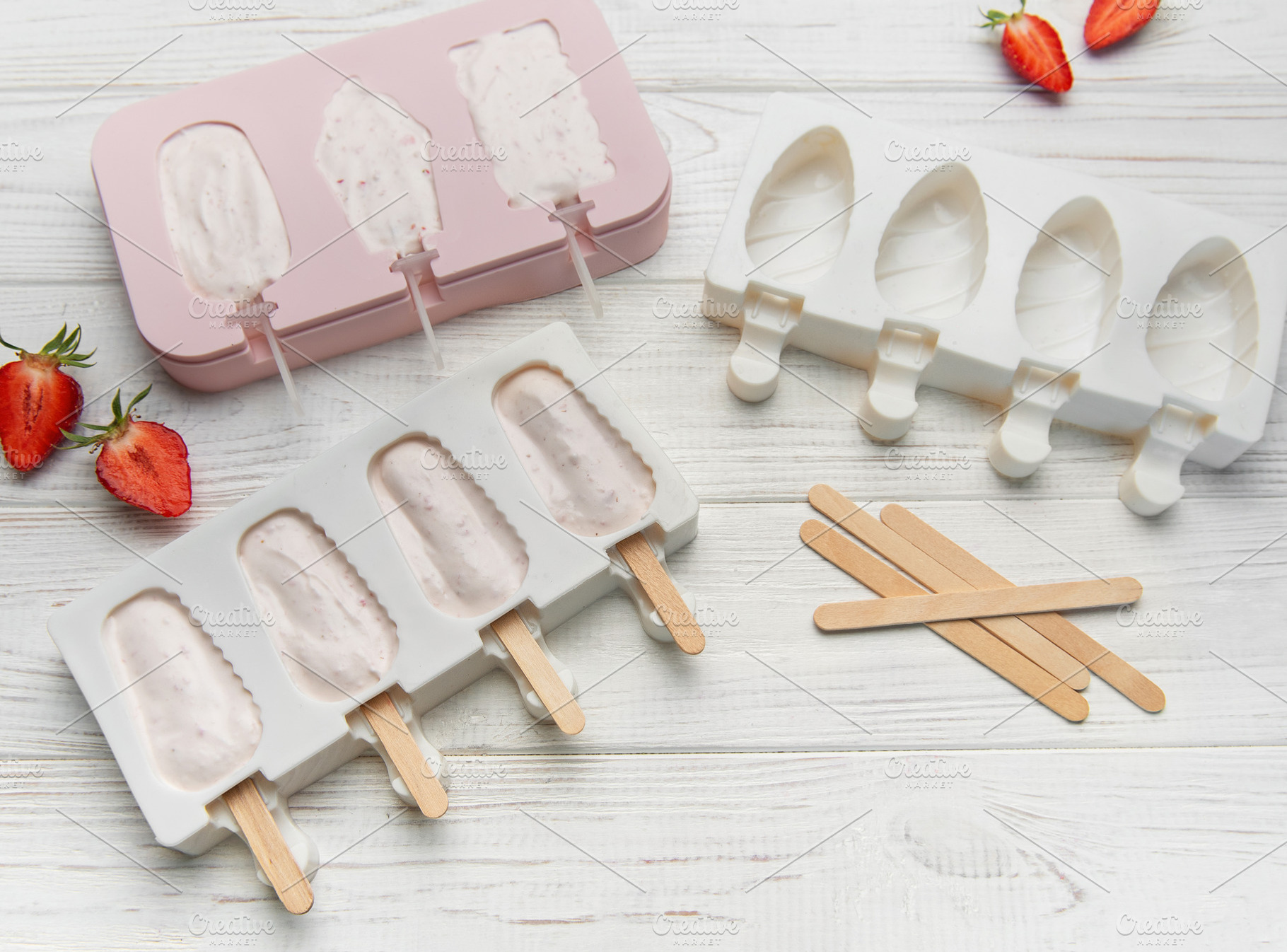 Preparing homemade strawberry ice cream bars in silicone molds, a Food & Drink Photo by Olena Rudo