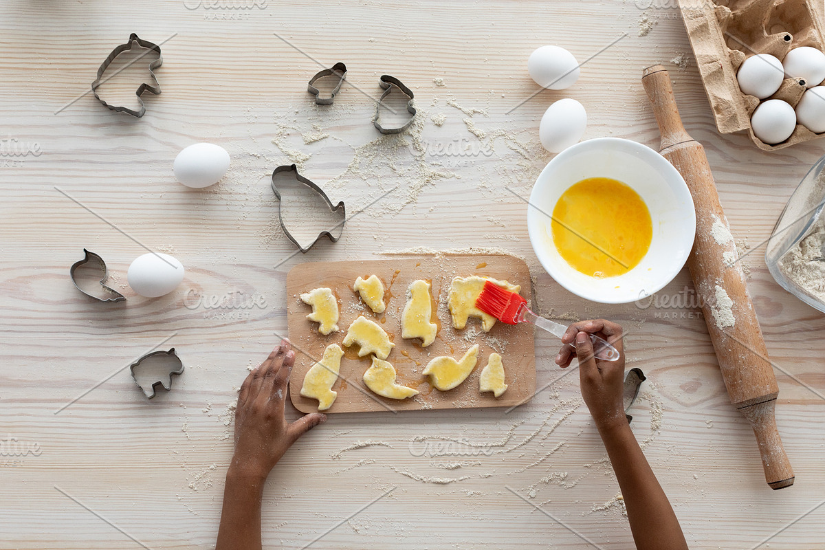 Unrecognizable black girl making cookies, top view, a Photo by Prostock-Studio (Photo 1 of 2)