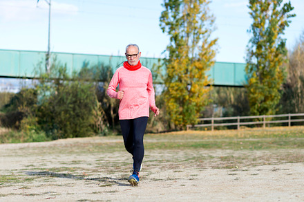 Senior man running outdoors in sportswear