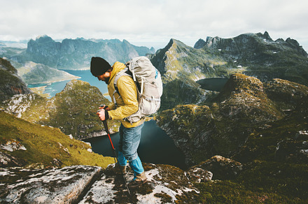 Adventurer man hiking with backpack, a Sports & Recreation Photo by e v e r s t