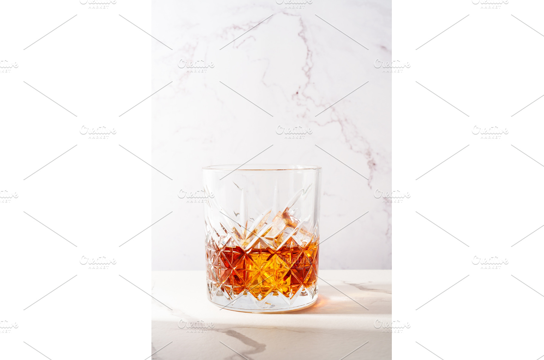 Whiskey with ice cube in the glass, a Food & Drink Photo by Nadia-nb
