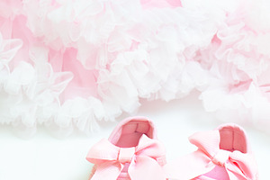 Baby's bootees containing background, concept, and girl