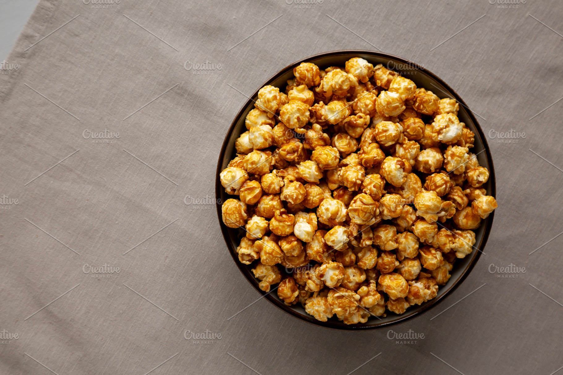 Homemade Caramel Pop Corn in a Bowl, top view. Space for text., a Food & Drink Photo by LiudmylaChuhunova