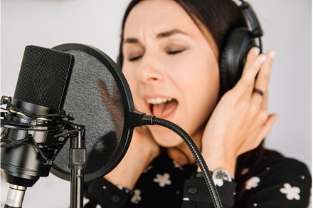 Beautiful woman in headphones sings