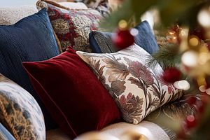 Cozy living room sofa with decorative cushions, Christmas tree lights and festi, a Holiday Photo by Studio ANNA