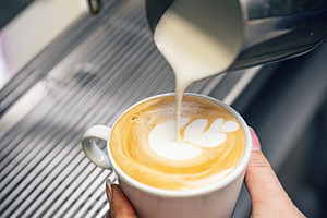 Barista preparing a cappuccino, a Photo by Grafvision photography