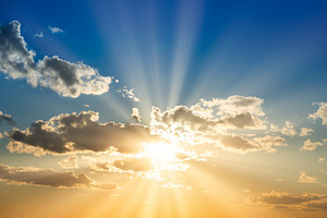 Sunset sky with clouds and sun