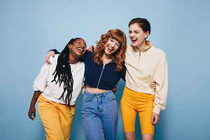 Diverse female friends laughing and having a good time while emb, a Person Photo by Jacob Lund