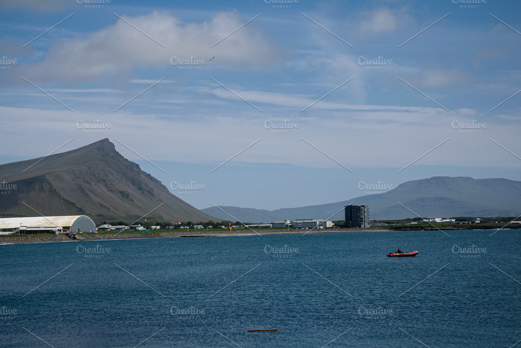 Serene view of Akranes coast with mountain and calm water in Iceland, a Photo by AS photostudio