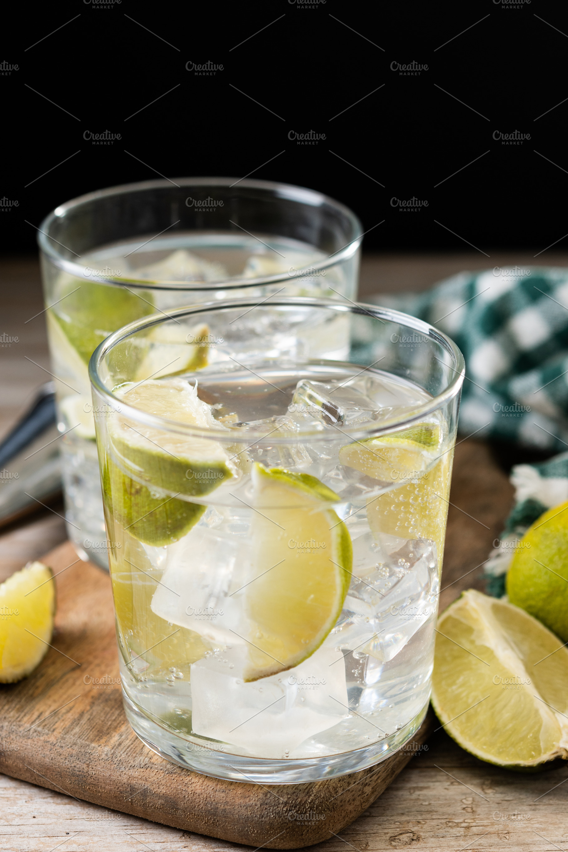 Glass of vodka tonic cocktail on wooden table, a Food & Drink Photo by etorres69