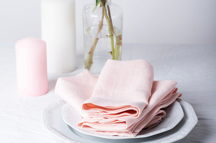 White linen tablecloth and pink napkins