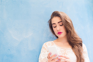 Cute girl playing with her phone stock photo containing arabic and attractive