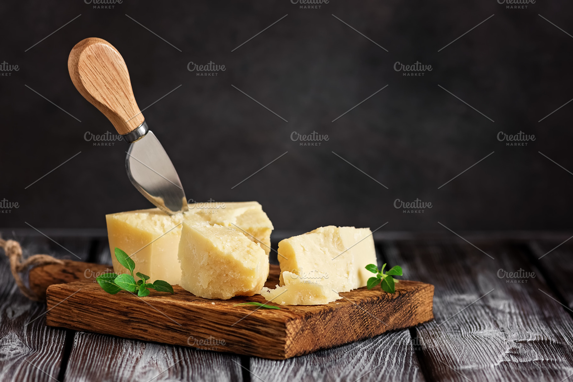 Parmesan cheese on a cutting board w, a Food & Drink Photo by Yulia71