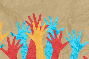 Multicolored paper hands raised against a background of crumpled, an Abstract Photo by ndanko