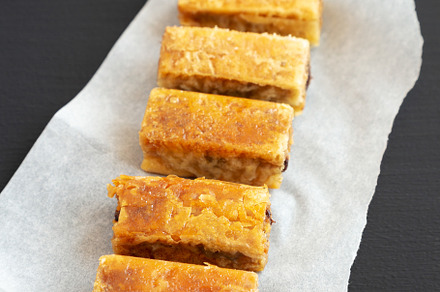 Homemade Baklavas with Honey, Chocolate and Almond on a black ba, a Food & Drink Photo by LiudmylaChuhunova