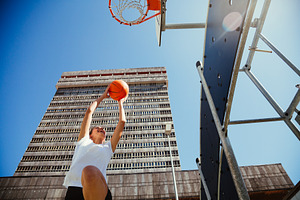 Girl playing basketball outdoors in