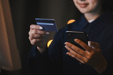Business, bank and hands with credit card and phone in office at night for virtual purchase, payment and sale. Ecommerce, technology and woman with smartphone for internet banking or online shopping, a Photo by Peopleimages.com