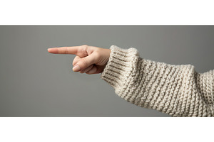 Hand in sweater pointing to the left, a Beauty & Fashion Photo by piter.goskov