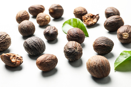 Nutmegs and leaves, close up and selective focus, a Food & Drink Photo by AtlasStudio PRO