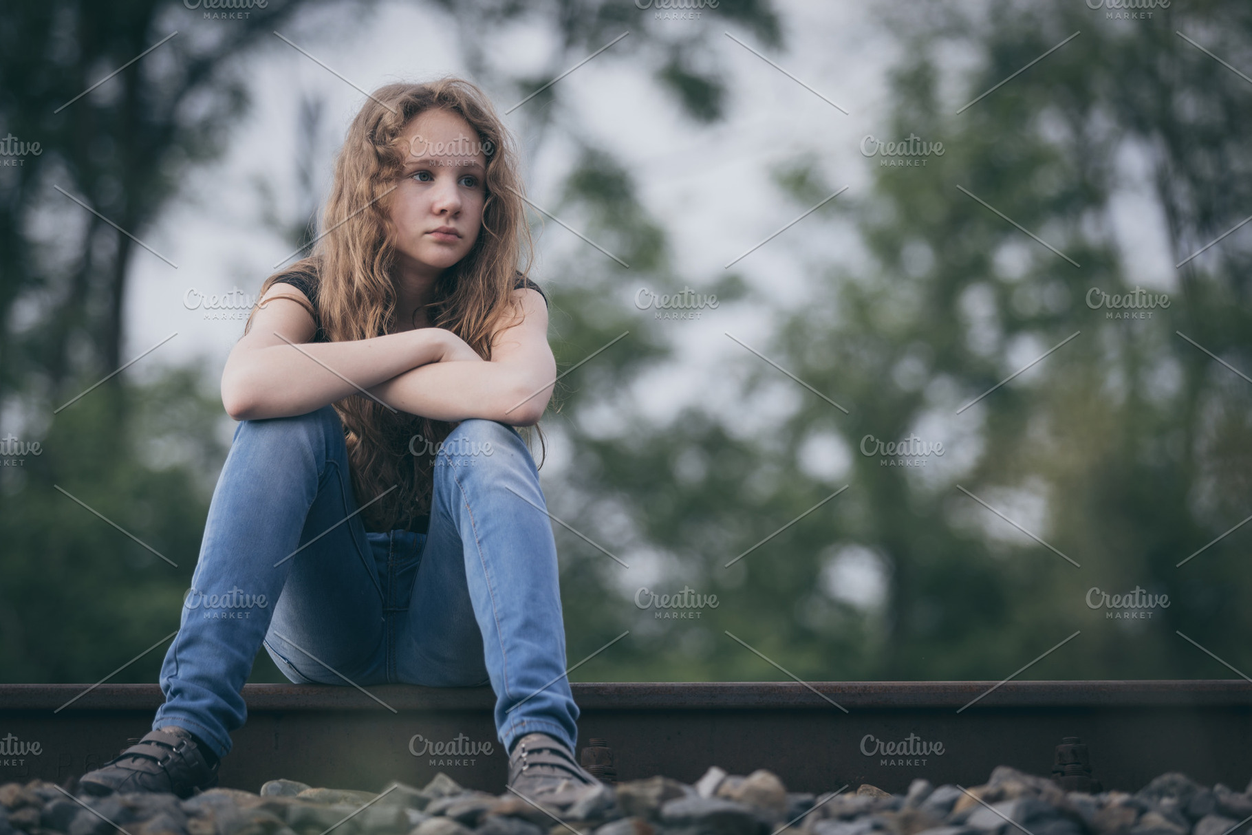 Portrait of young sad teen girl featuring sad, autism, and girl, a Person Photo by altanaka