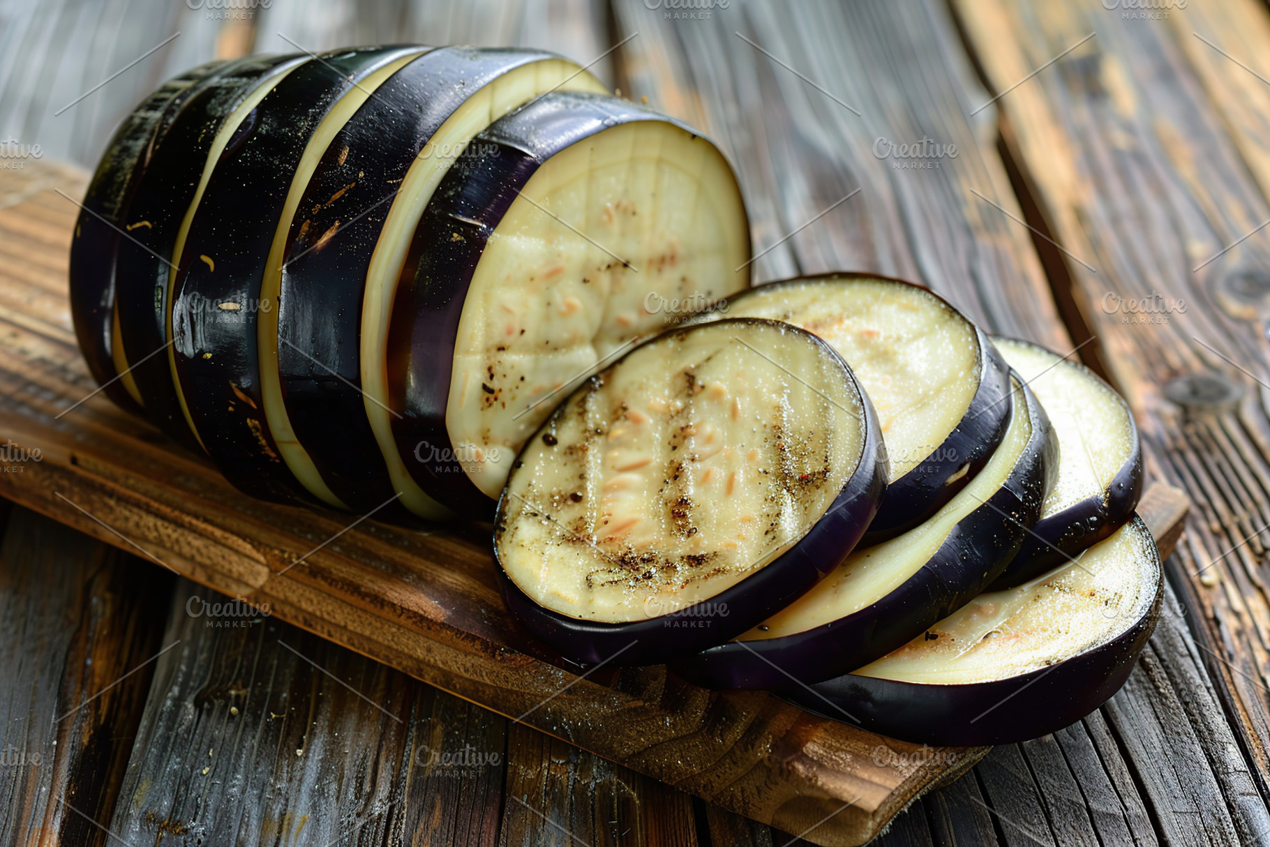 Fresh pieces of eggplant on wooden background, a Food & Drink Photo by AlyaAnd