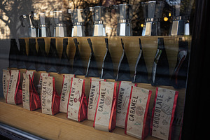 Showcase of artisanal coffee bags and brewers in Lviv's local store, a Photo by AS photostudio