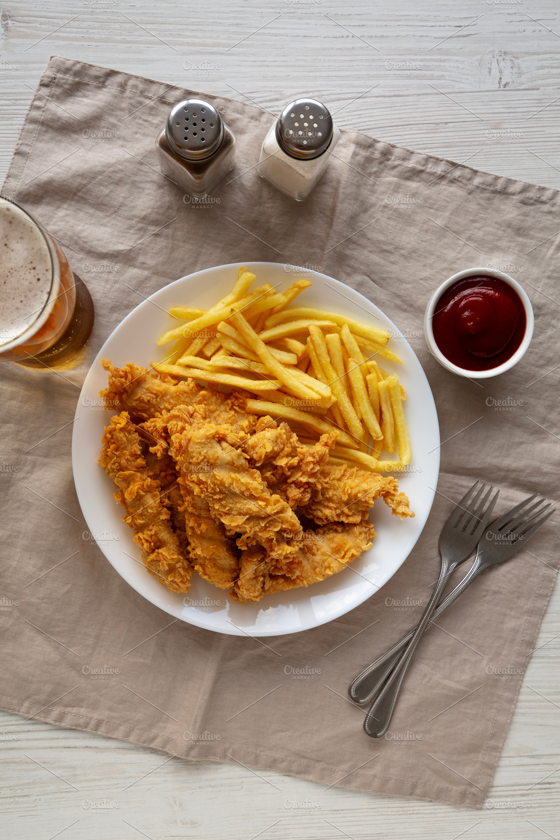 Homemade Chicken Strips with Fries on a Plate, top view. Flat la, a Food & Drink Photo by LiudmylaChuhunova