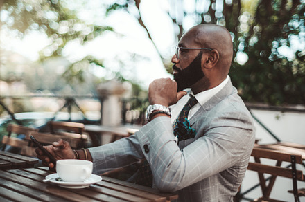 Black man entrepreneur in a cafe, a Person Photo by SkyNext