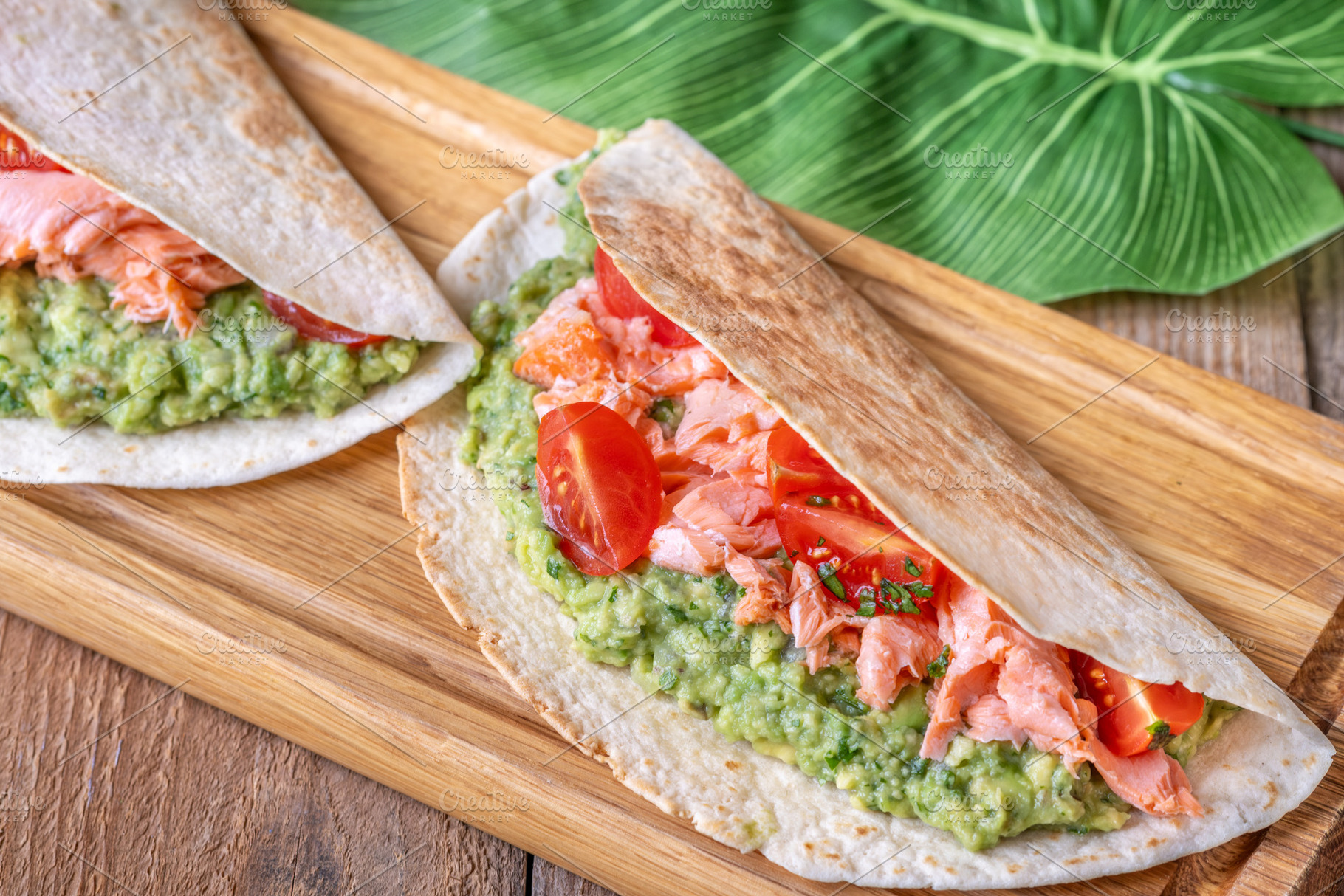 Salmon Tacos with Guacamole and Tomatoes on Rustic Table, a Food & Drink Photo by Alexander Prokopenko