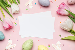 Easter greeting card mockup with colorful eggs and tulips on pin, a Holiday Photo by Olena Rudo