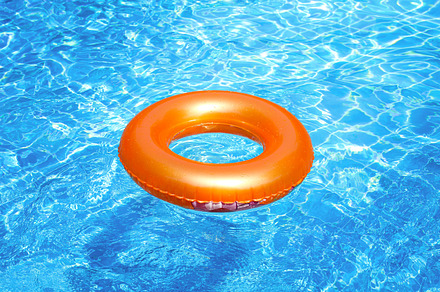 Orange pool float featuring beach, pool, and safe