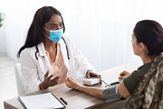African American Doctor Lady Making Health Condition Check Up For Female Soldie, a Photo by Prostock-Studio (Thumbnail 1 of 2)