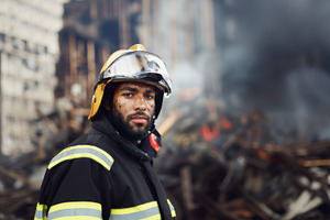 Firefighter facing camera with determined expression, emergency, a Photo by Dvoevnore photos