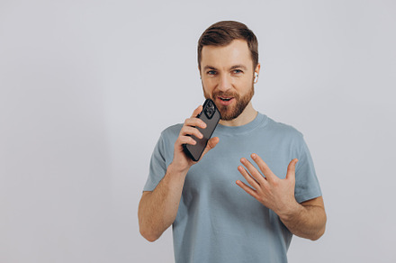Happy bearded man dancing with earphones, listening music in hea, a Technology Photo by Cherkas Photography