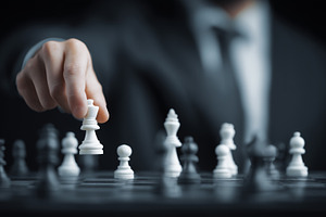 Businessman in a suit makes a move, a Business Photo by MistyDay