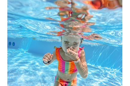 Little girl in swimsuit diving in, a Sports & Recreation Photo by HalfPoint