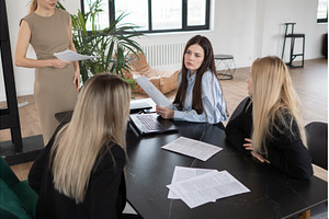 Three businesswomen are discussing, a Business Photo by undrey