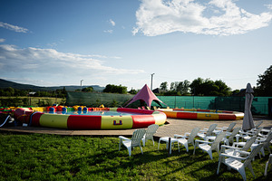 Outdoor inflatable play area with colorful pools and seating under clear sky, a Photo by AS photostudio