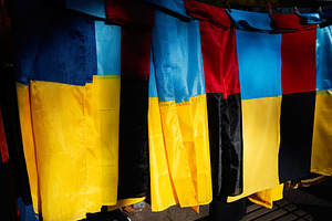 Colorful Ukrainian flags with designs on display in an outdoor Lviv market, a Photo by AS photostudio