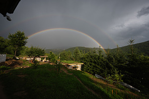 Scenic view of double rainbow over green landscape and cloudy sky, a Photo by AS photostudio