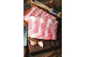 Raw pork ribs with spices, salt and, a Food & Drink Photo by Budarinphoto
