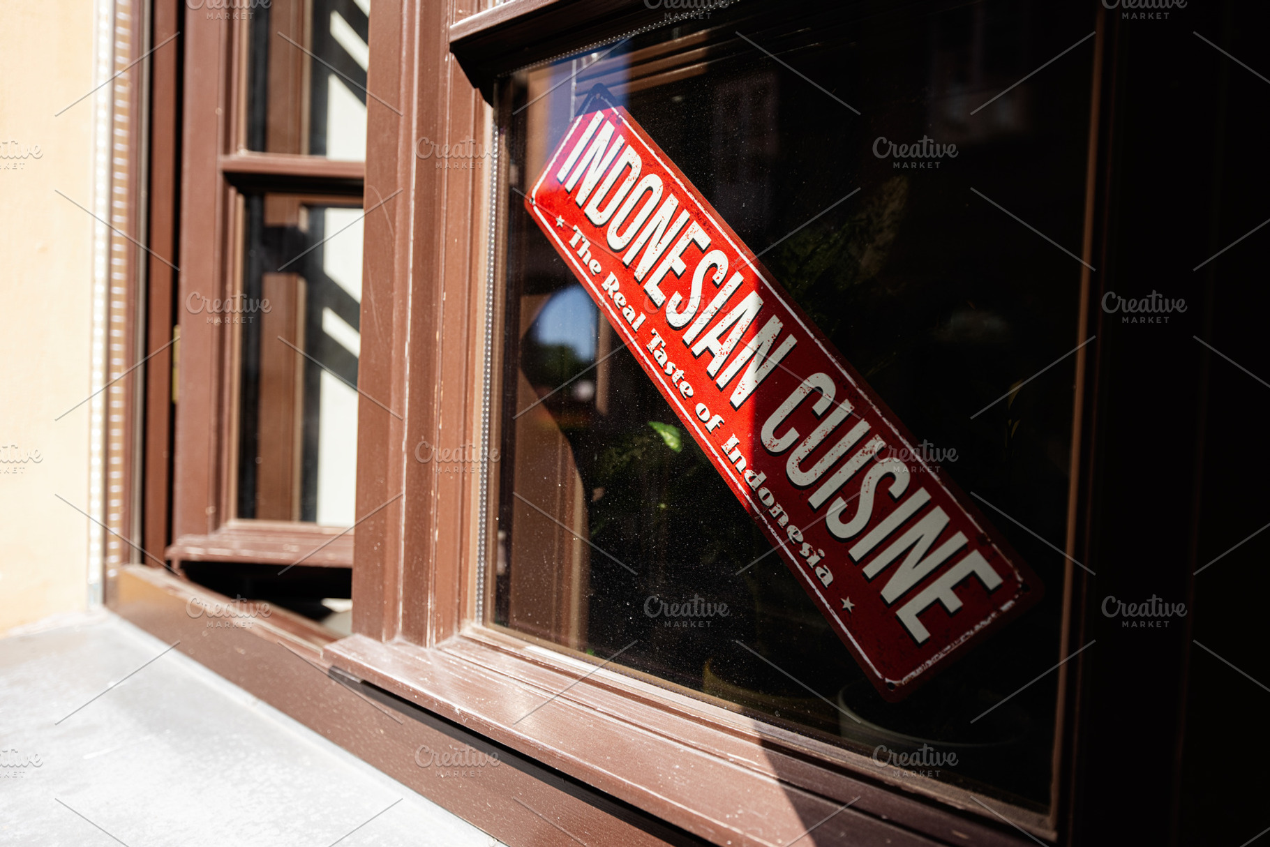 Indonesian cuisine sign on a closed window in bright natural light, a Photo by AS photostudio