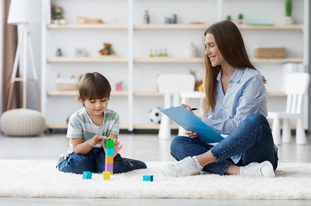 Gentle psychological exam. Professional woman kids specialist watching little p, a Photo by Prostock-Studio