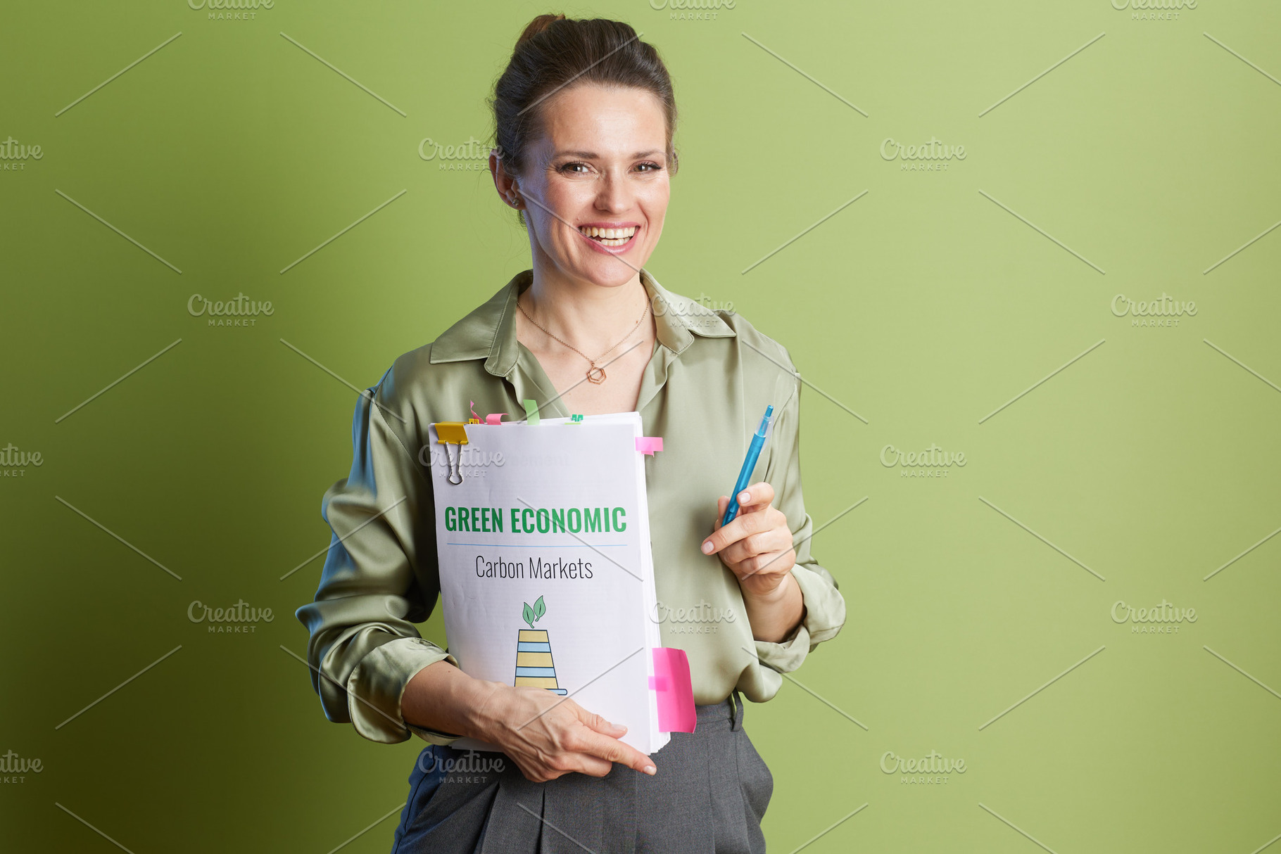 Green Economy Expertise: Woman with Carbon Markets Folder, a Business Photo by Alliance Images