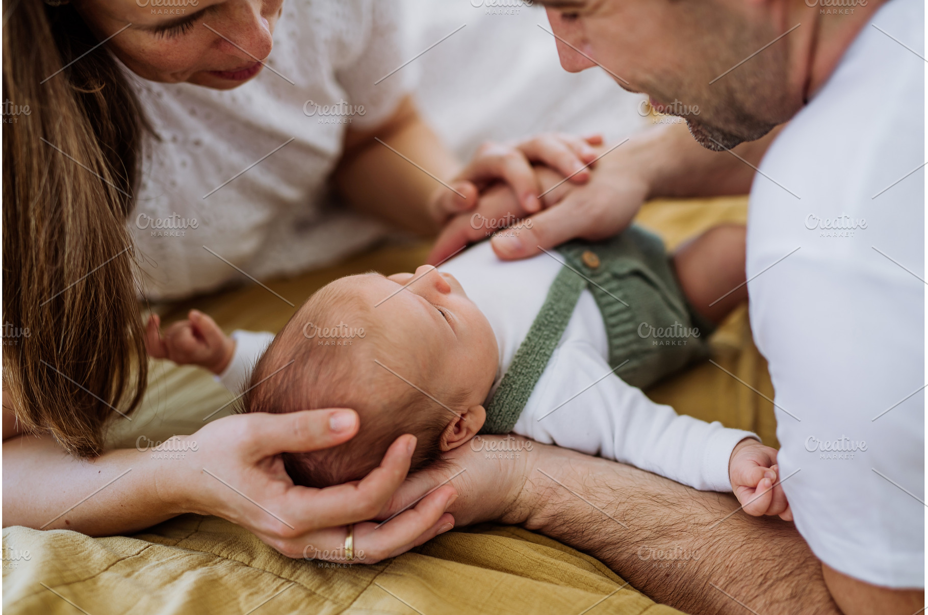 Happy parents cuddling with their, a Person Photo by HalfPoint